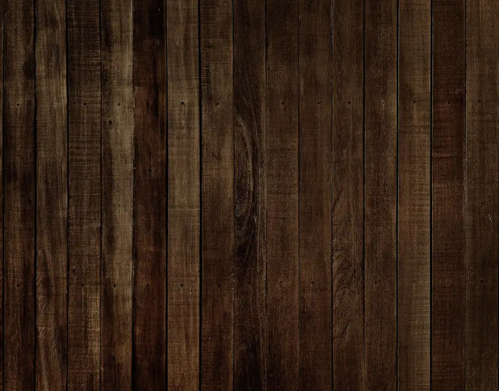 Small living room with wood flooring boards laid lengthwise to visually widen the space