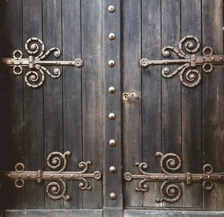 Wood gate hardware kit installed on a backyard fence gate with tools nearby