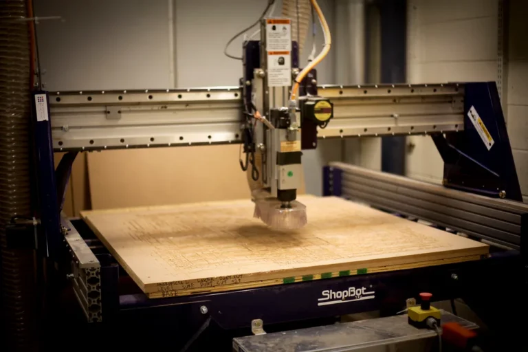 Beginner wood router choice on a workbench with practice board in a small workshop
