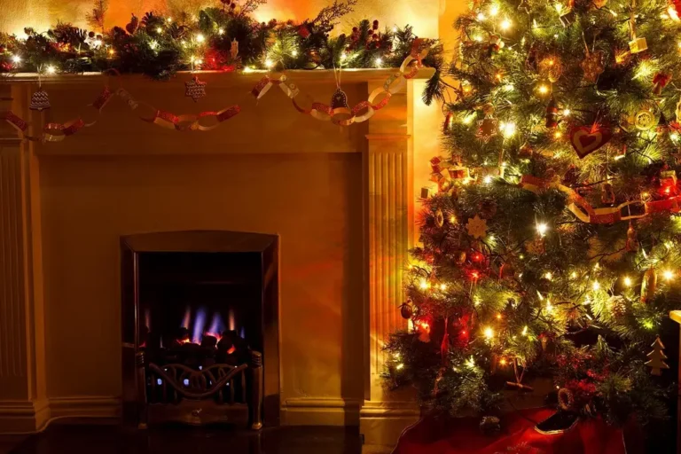 Homeowner carrying a Christmas tree away from a fireplace in a naturally lit living room