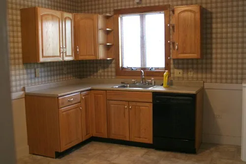 Hands cleaning a matte hardwood floor with a microfiber mop and spray bottle