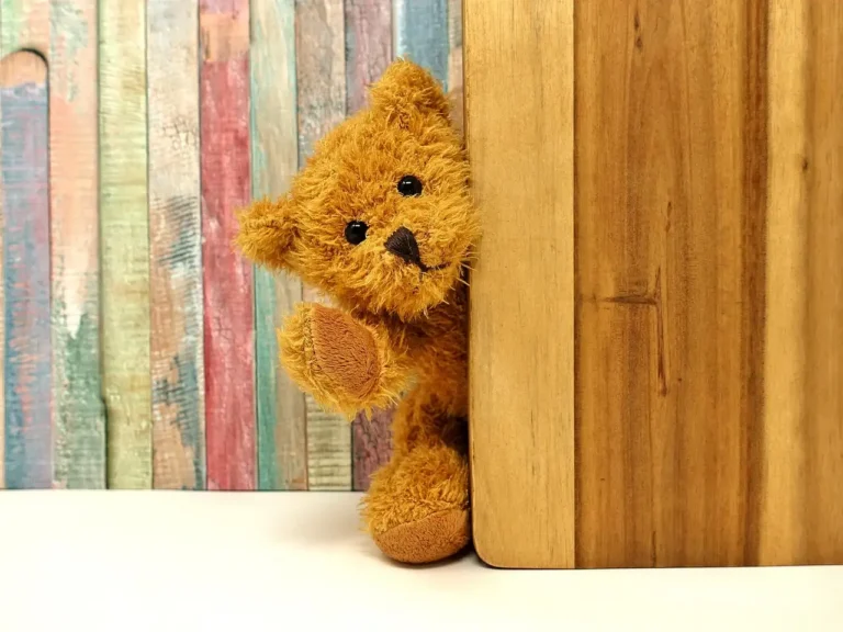 Parent and child choosing a wooden toy box in a bright playroom with tools and lumber nearby