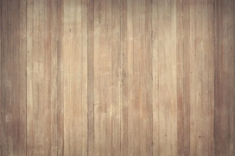 Homeowner and contractor comparing solid hardwood and engineered hardwood samples in a sunlit living room