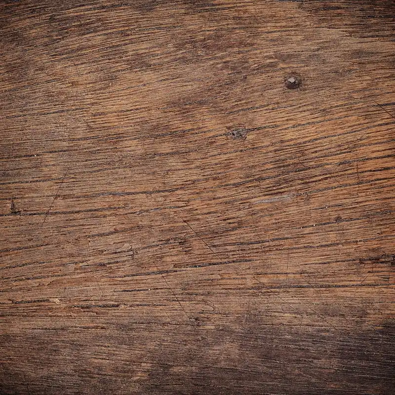 Stacked oak lumber samples beside woodworking tools in natural light