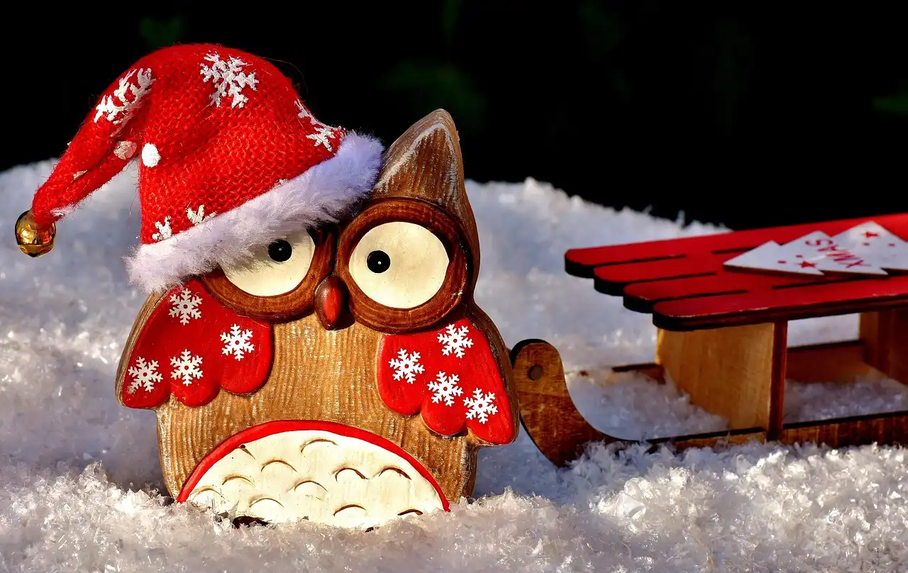 Wooden Santa hat ornament blank on a workbench with paint and sanding tools